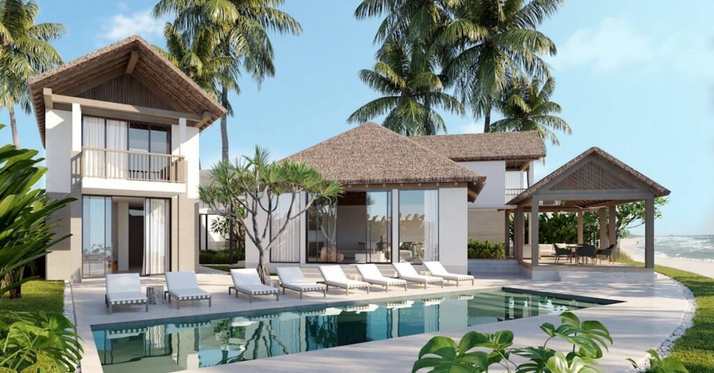 Elegant tropical villa with a private pool, palm trees, and ocean view.